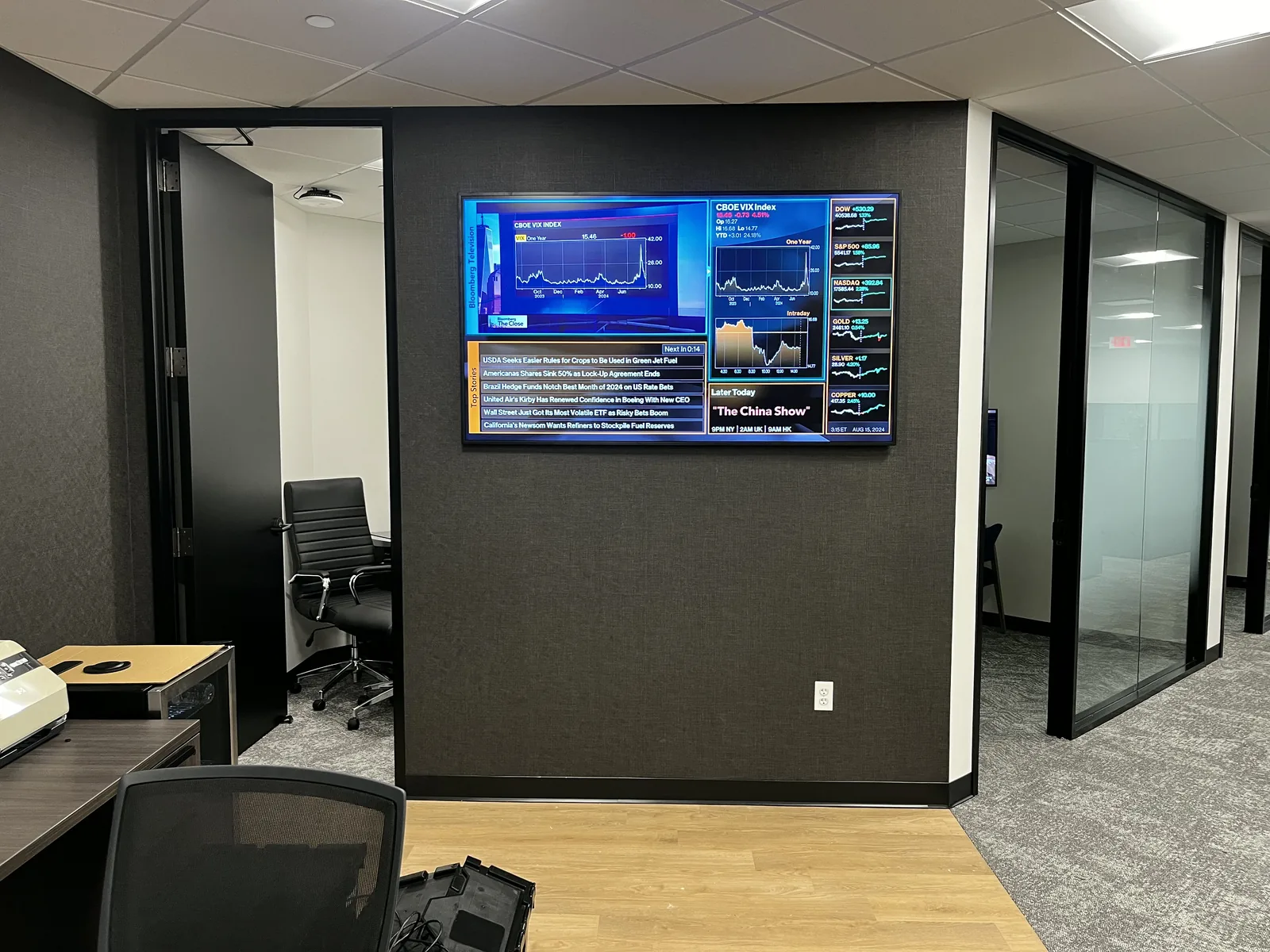 Office display wall with mounted screens in a finished commercial space